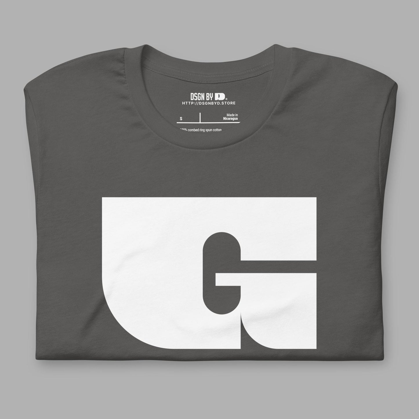 A folded grey cotton unisex graphic tee with letter G.