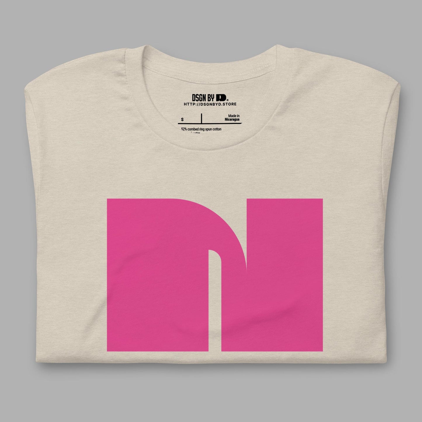 A folded beige cotton unisex graphic tee with letter N.