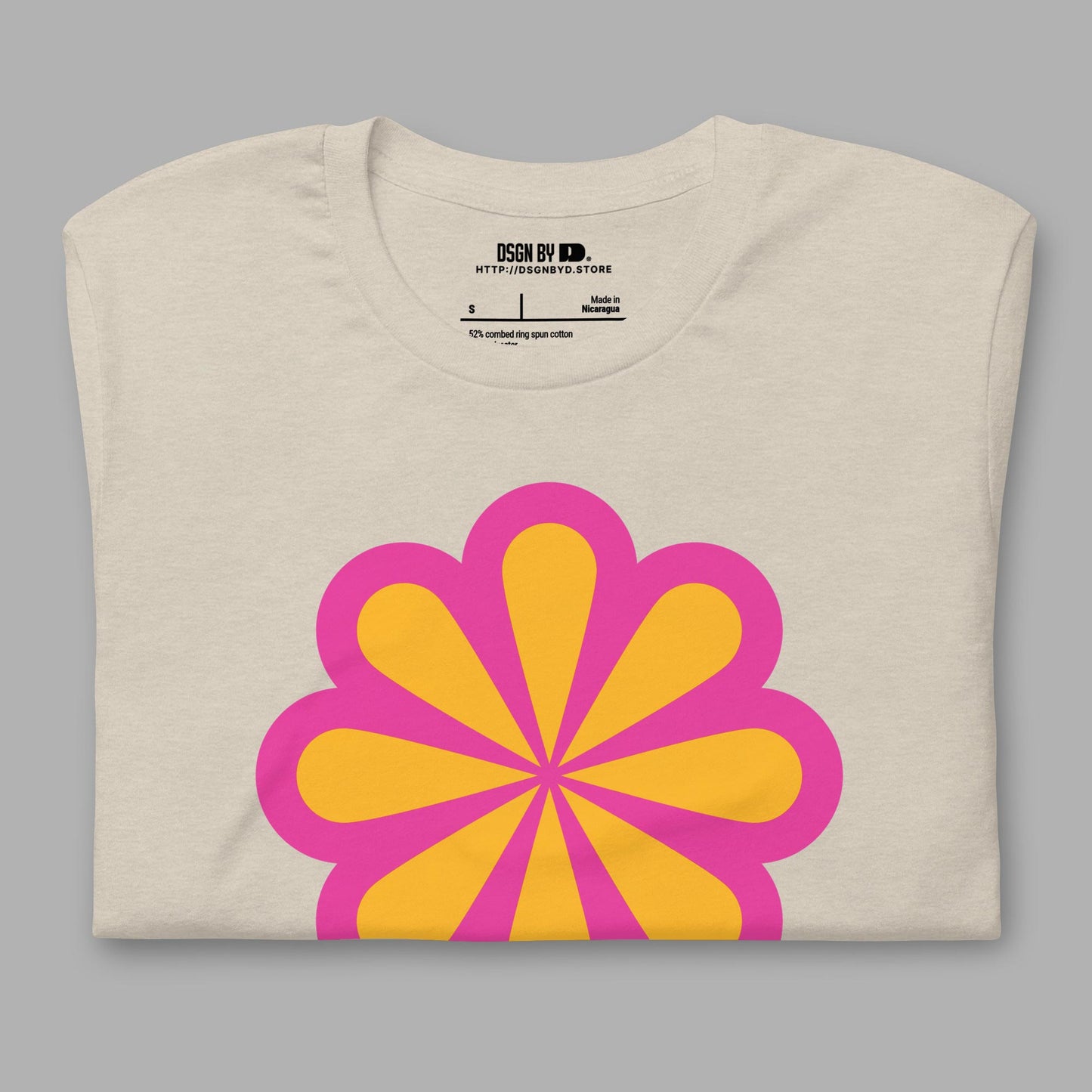 A folded beige cotton unisex graphic tee.
