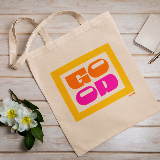 A cotton canvas tote bag with yellow, orange, and pink texts.