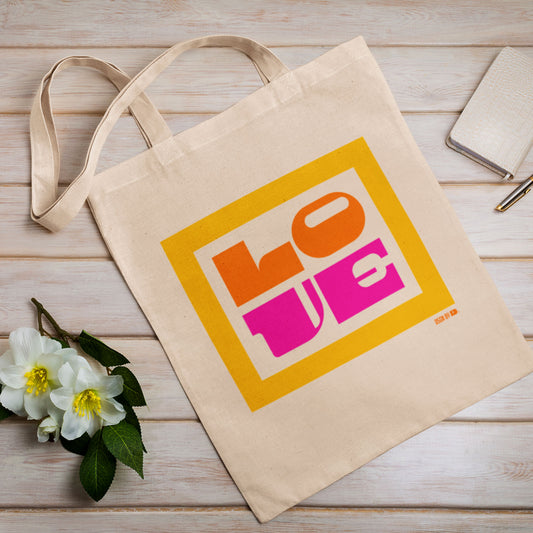 A cotton canvas tote bag with yellow, orange, and pink design.