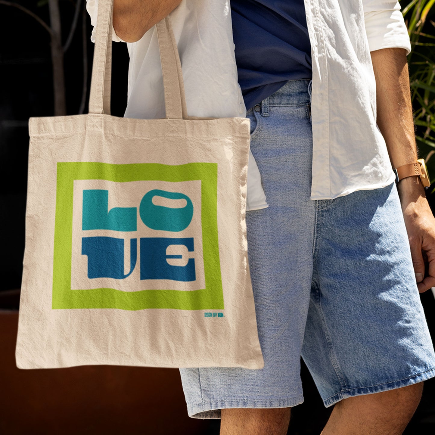 A man carrying cotton canvas tote bag.