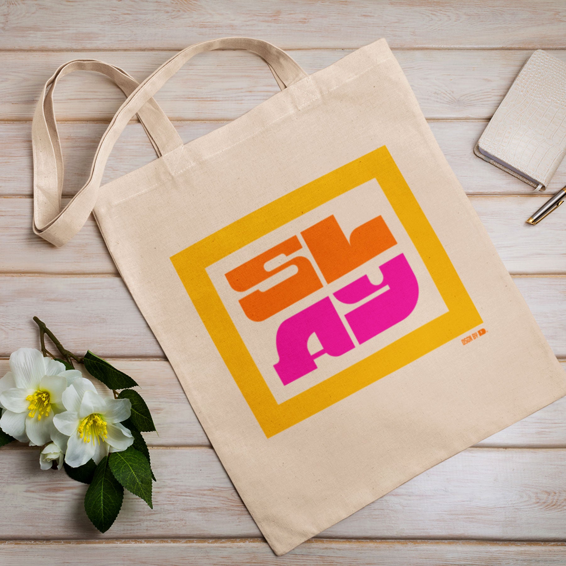 A cotton canvas tote bag with yellow, orange, and pink design.