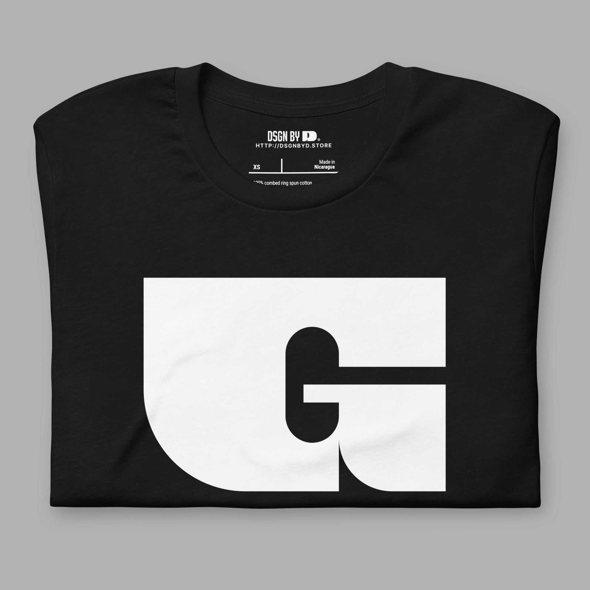 A folded black cotton unisex graphic tee with letter G.