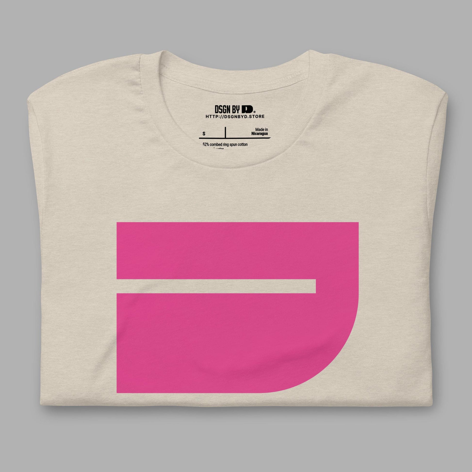 A folded beige cotton unisex graphic tee with letter J.