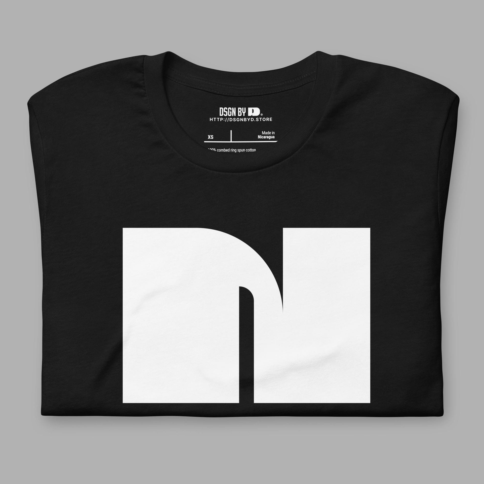 A folded black cotton unisex graphic tee with letter N.