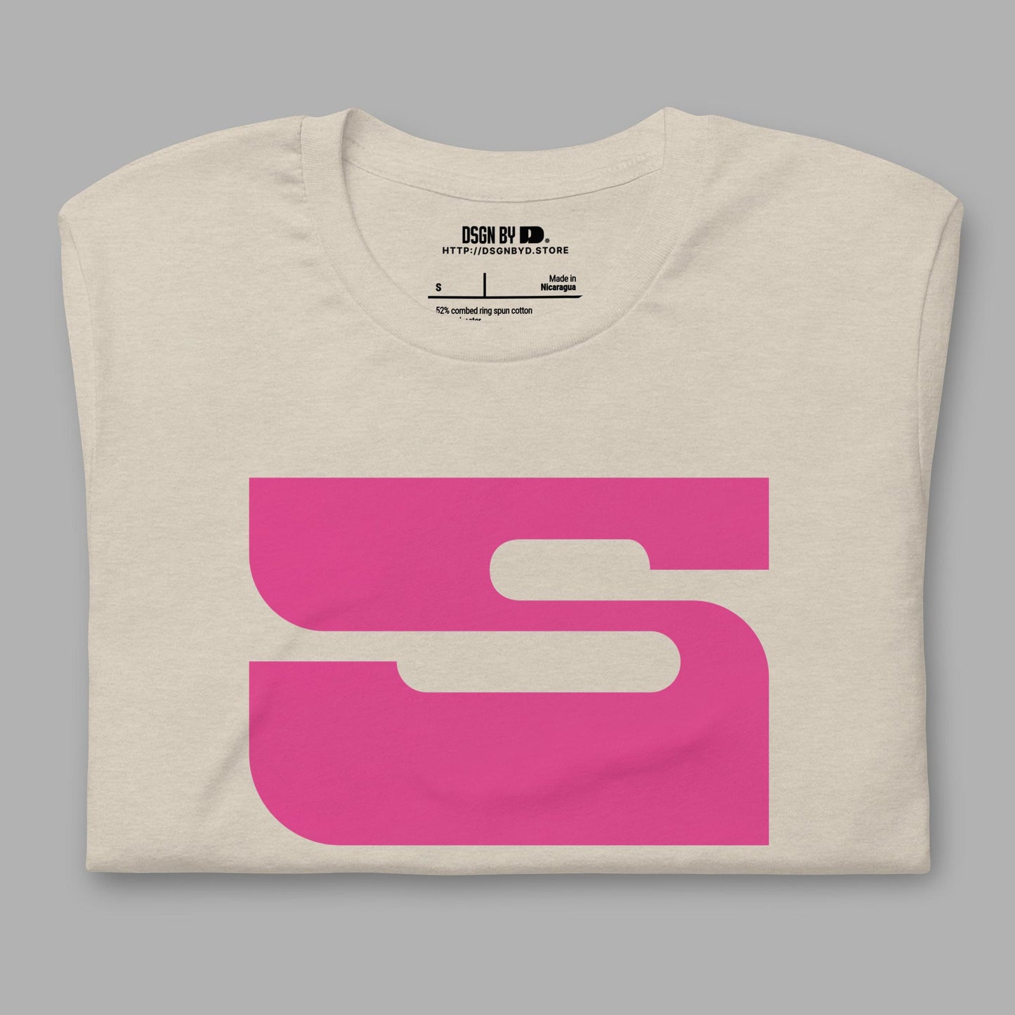 A folded beige cotton unisex graphic tee with letter S.