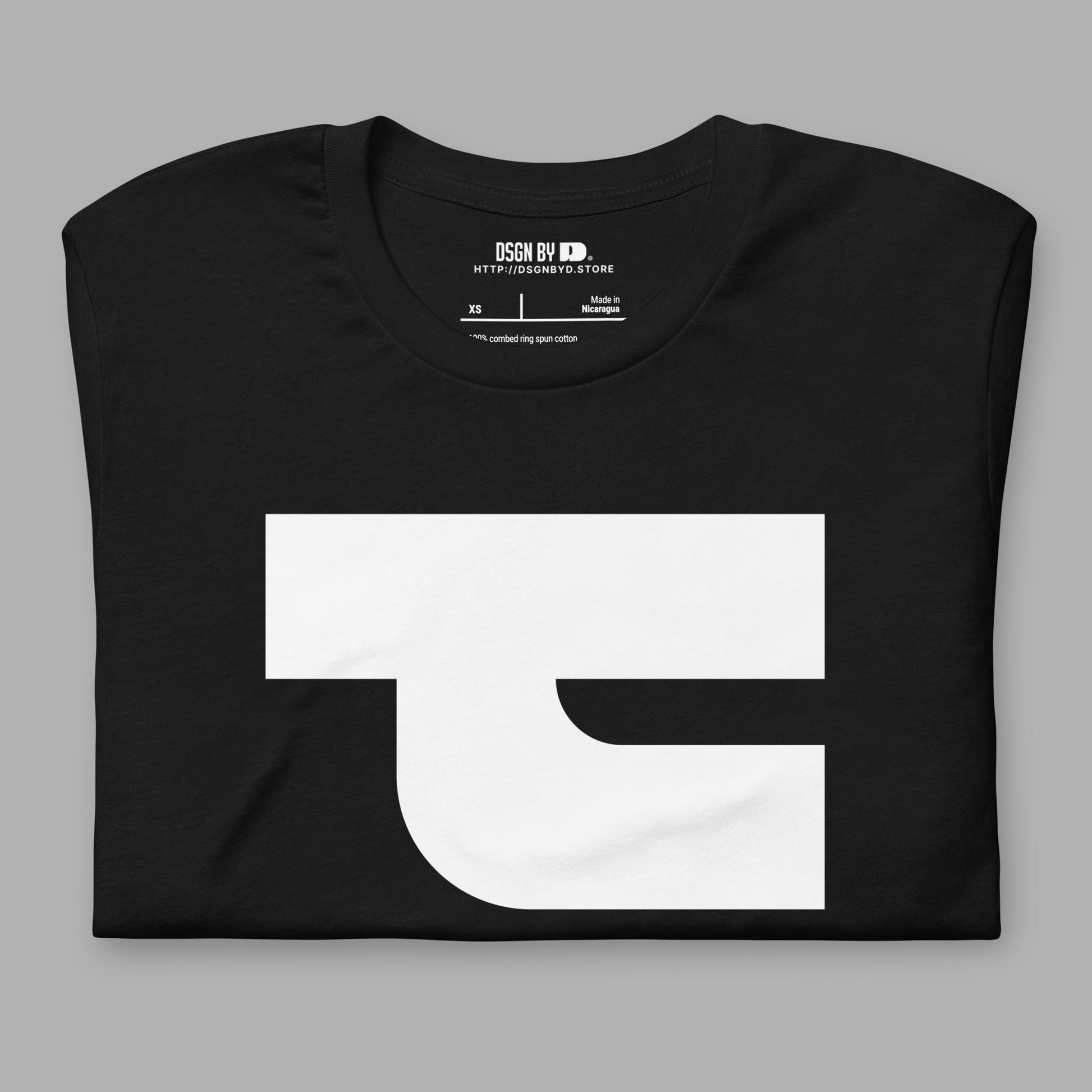A folded black cotton unisex graphic tee with letter T.