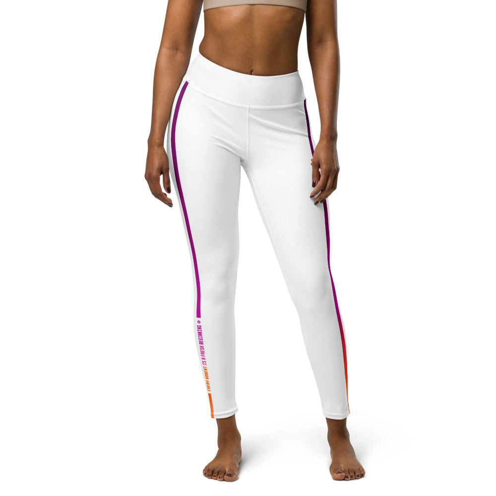 A fit and slender woman wearing white yoga leggings with orange and pink graphics.