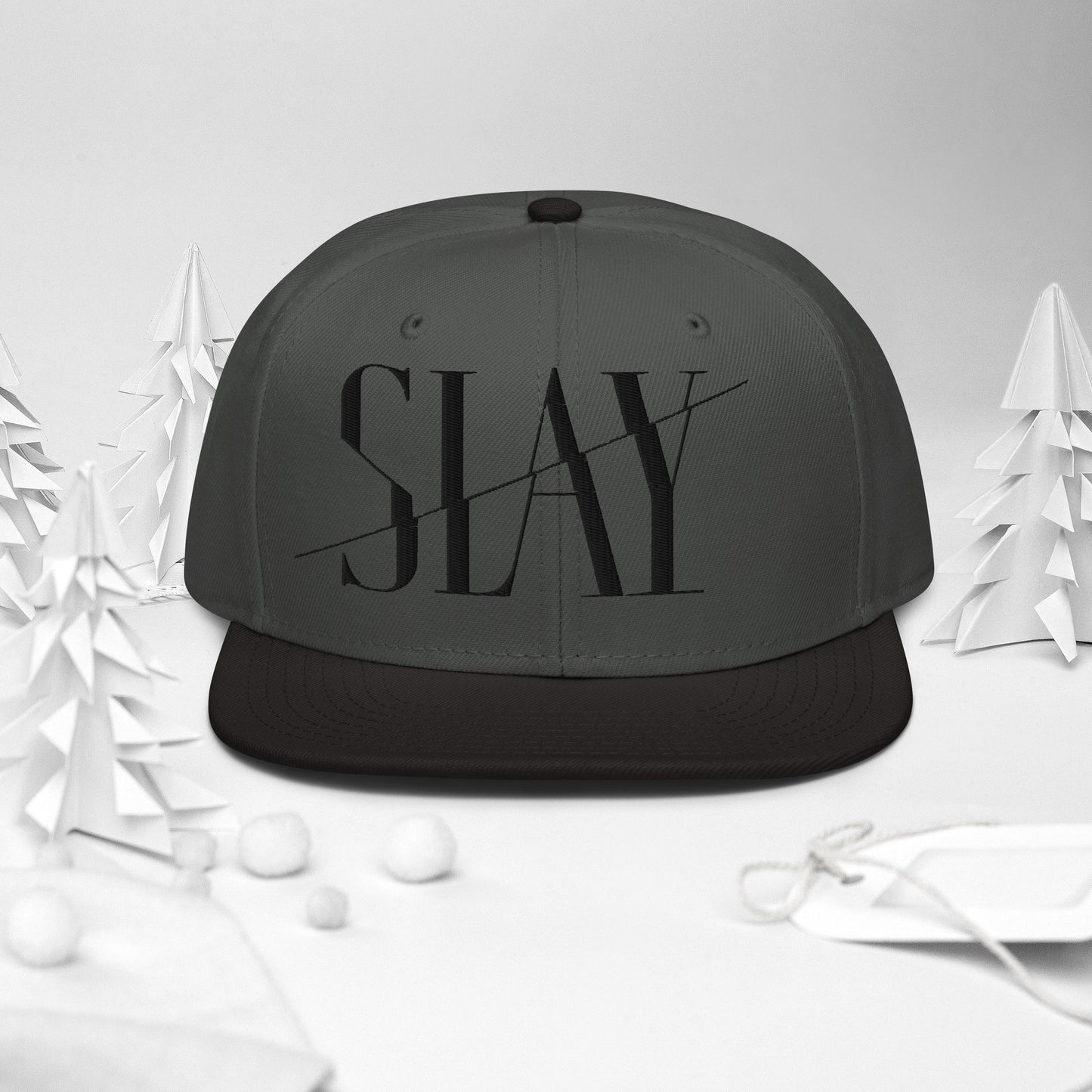 Front view of a black and grey Snapback Hat with the word "SLAY" embroidered on the front.