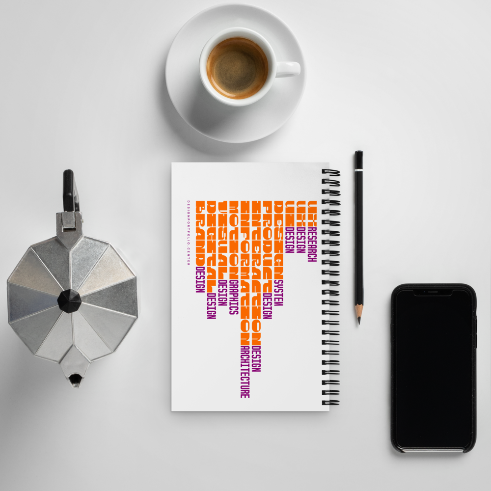 White notebook with colorful cover showing yellow, orange, pink, and purple typography showing design careers.