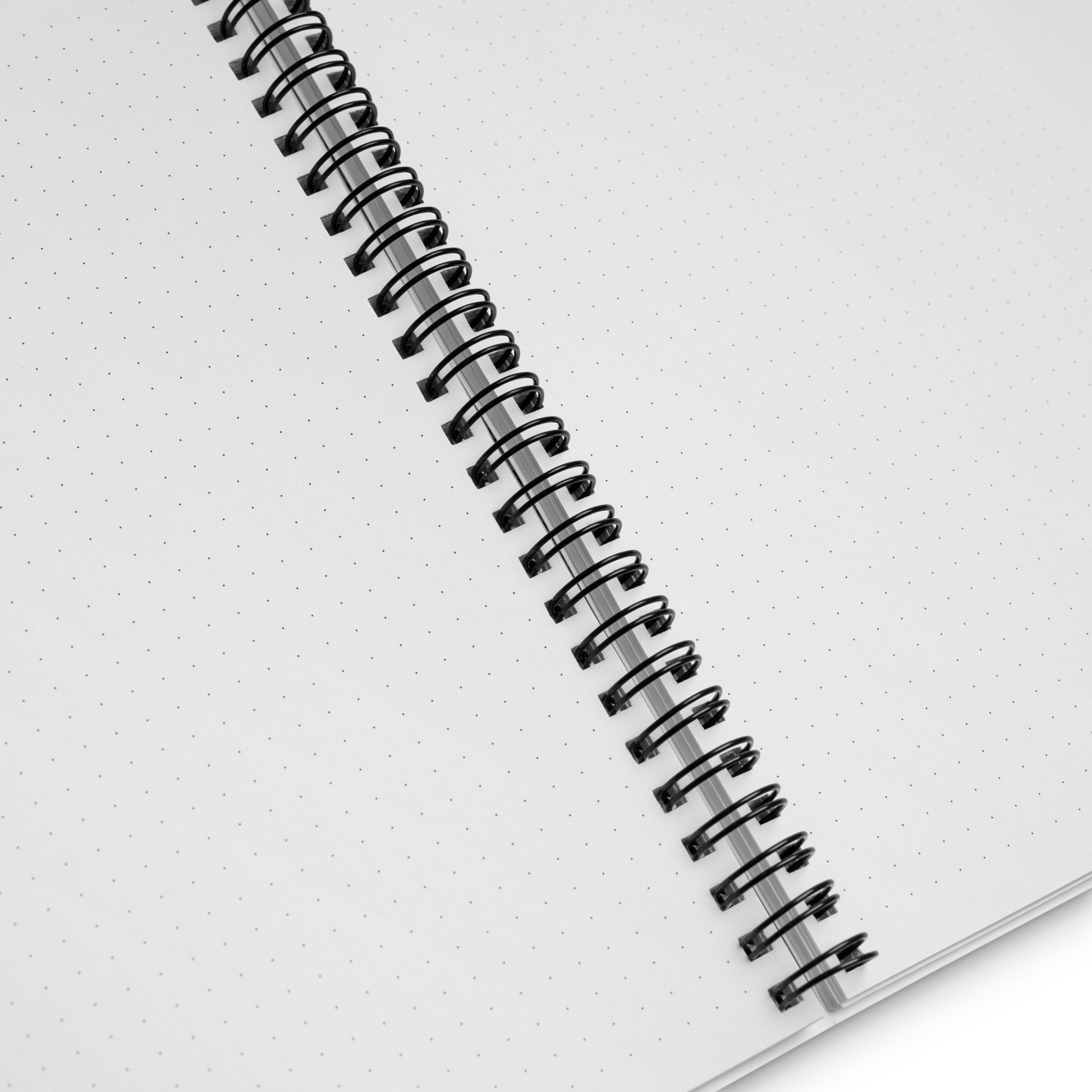 A spiral bound notebook with dot grid.